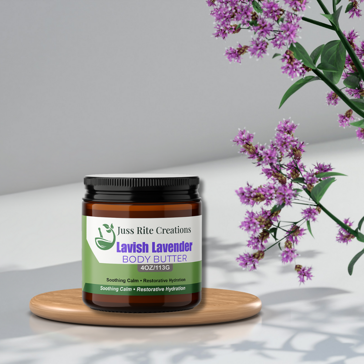 Jar of Juss Rite Creations Lavish Lavender Body Butter on a wooden board with lavender flowers in the background.
