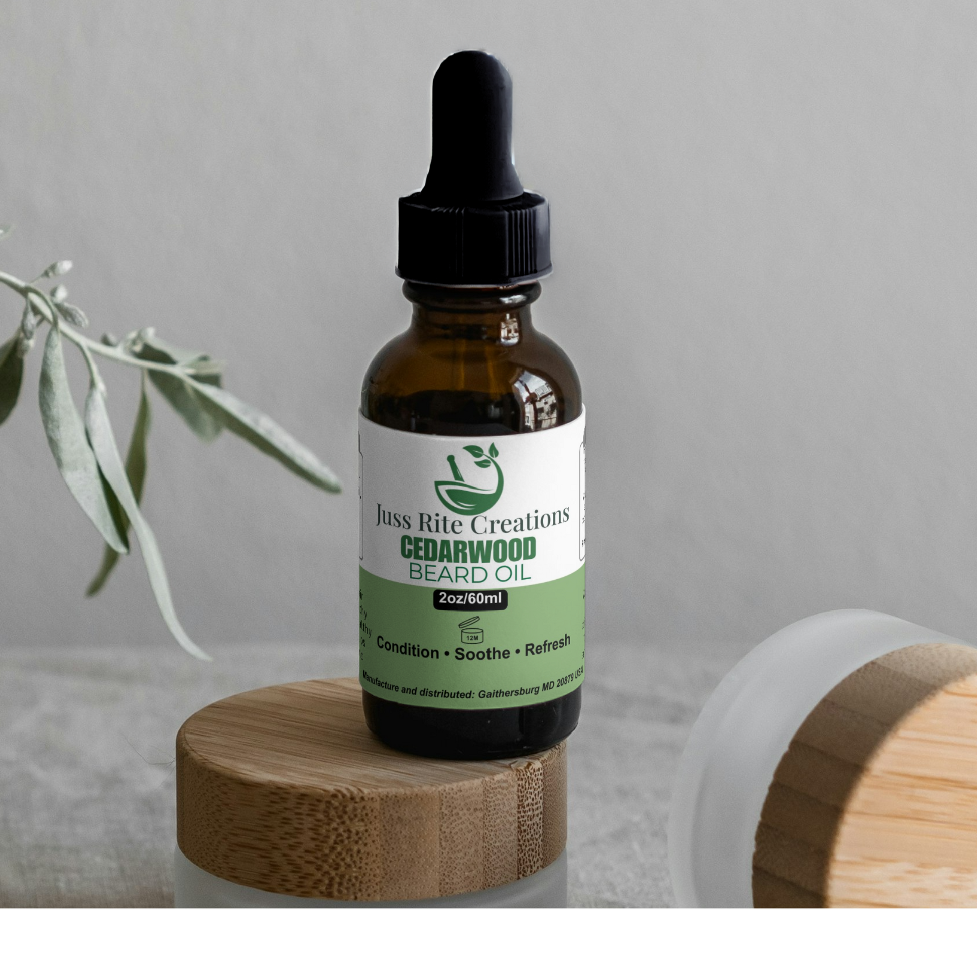Bottle of Juss Rite Creations Cedarwood Beard Oil on a wooden stand with a gray background