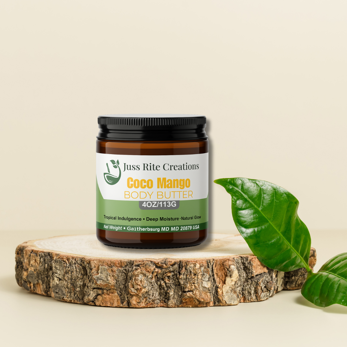 Jar of Coco Mango body butter from Juss Rite Creations on a wooden block with a leaf.